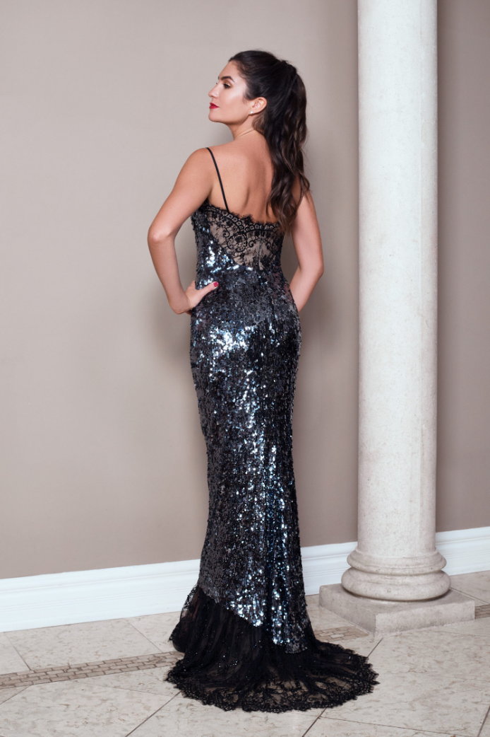 Black sequin mermaid evening gown with lace-framed neckline, built-in corset, slender straps, and a delicate beaded lace train.