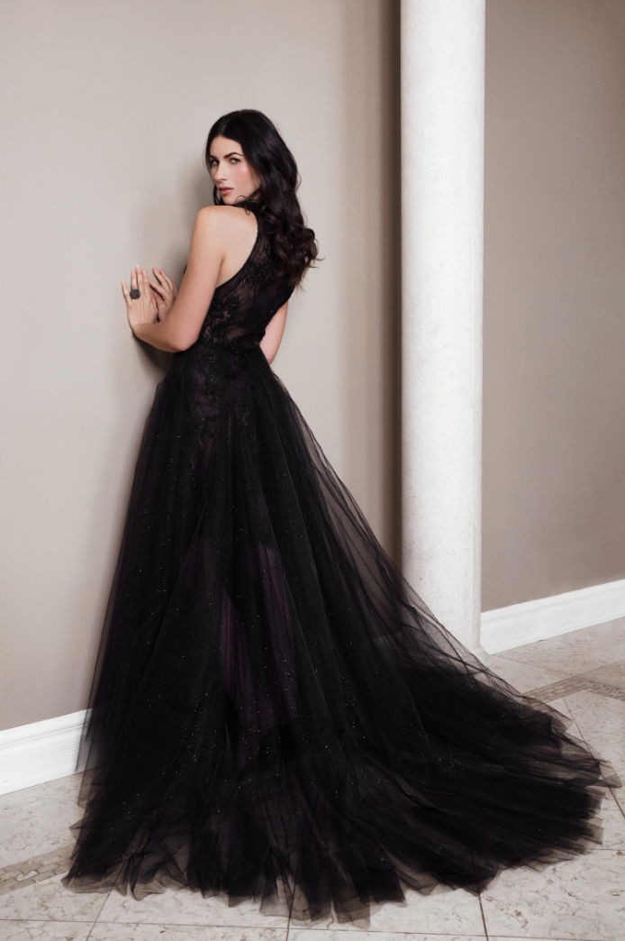 Black high-low overskirt made of layered glitter tulle with a tea-length front and a flowing two-foot train.