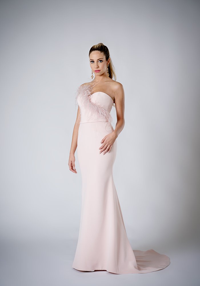 Blush silk crepe strapless evening gown with a built-in corset, ostrich feather detail, detachable belt, and elegant train in Toronto.
