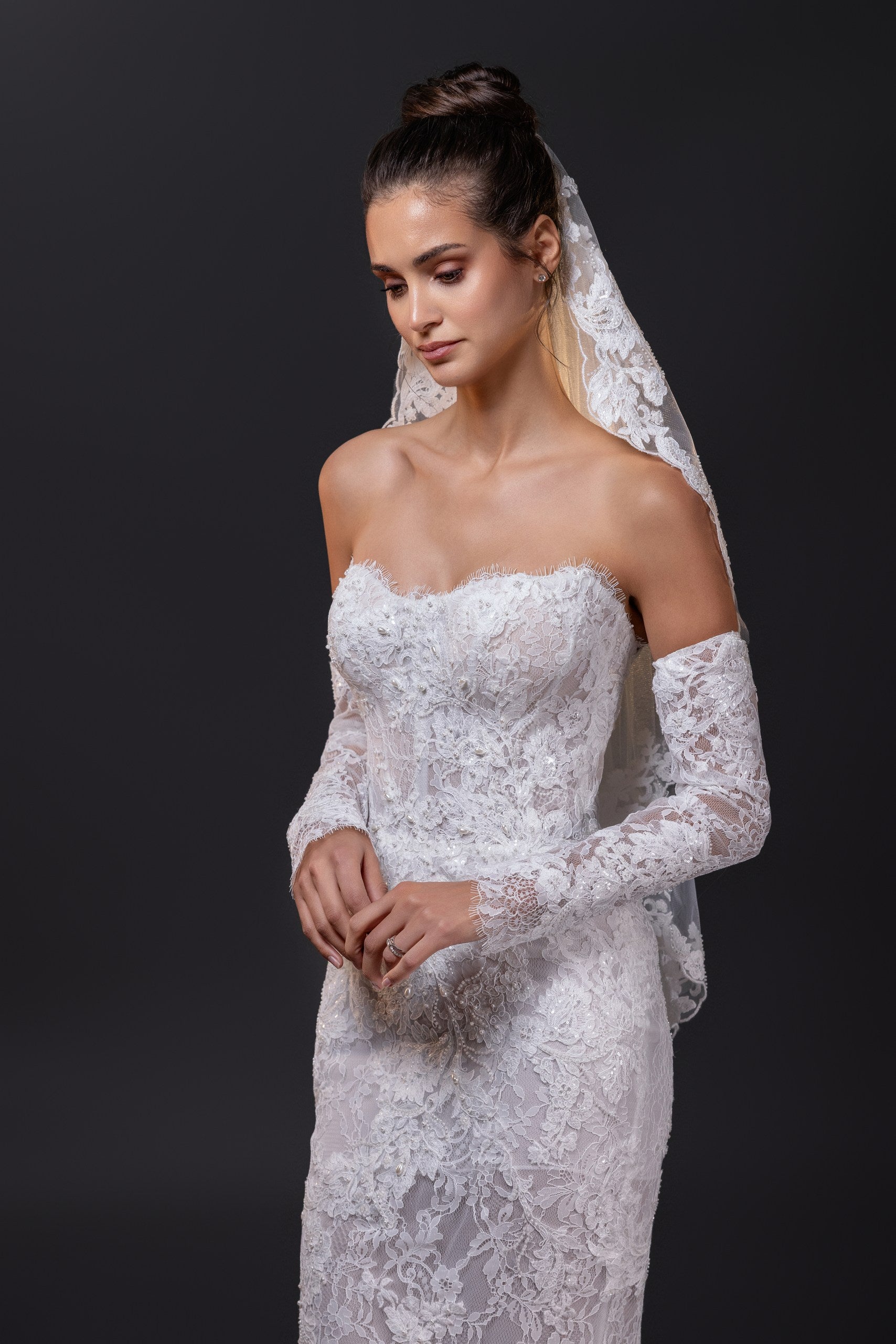 Francesca beaded lace strapless mermaid wedding gown with hand-cut appliqués, built-in corset, and dramatic lace train in Toronto.