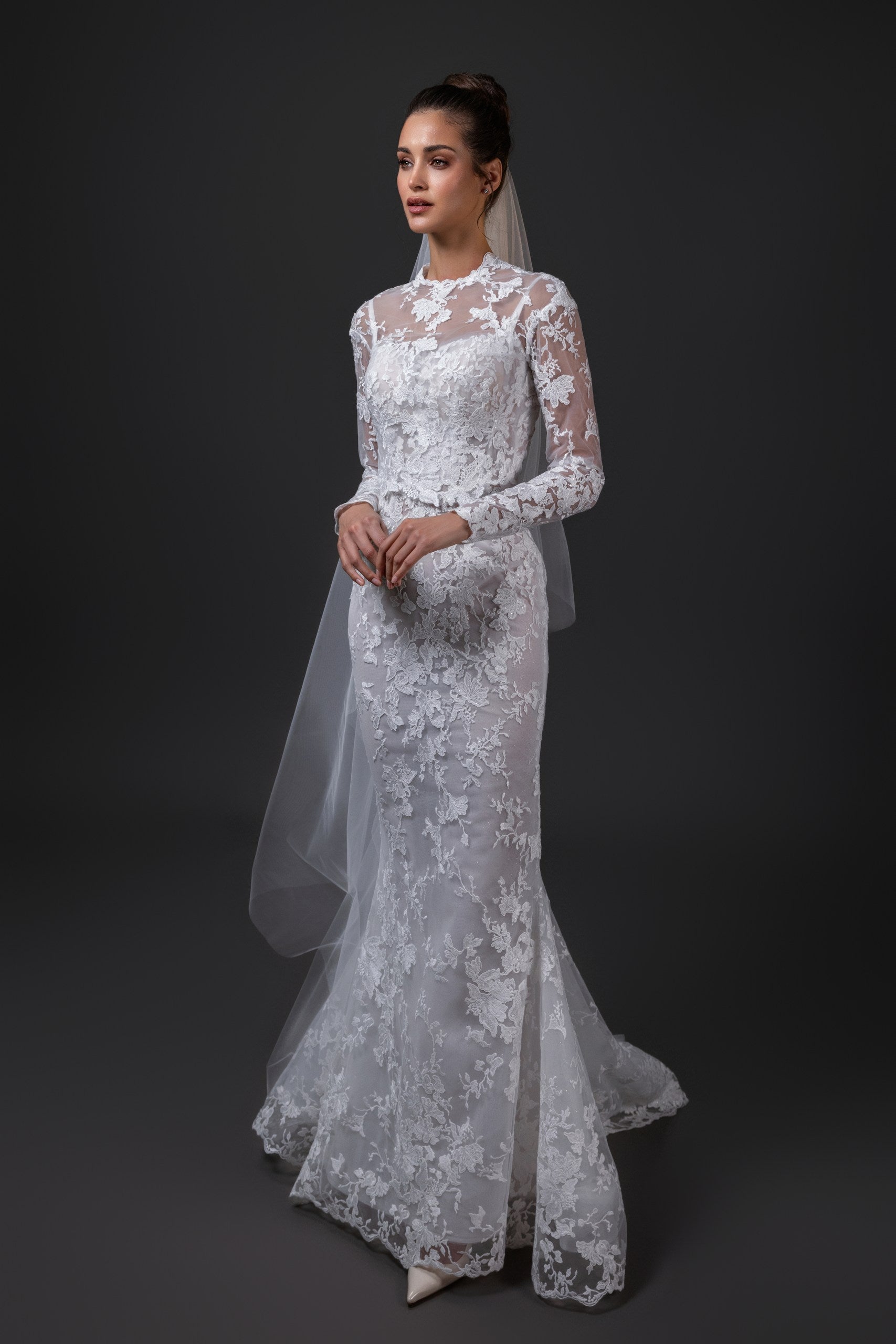 Michelle lace bridal topper with long sleeves, illusion neckline, and silk charmeuse bows, styled with a veil in Toronto.