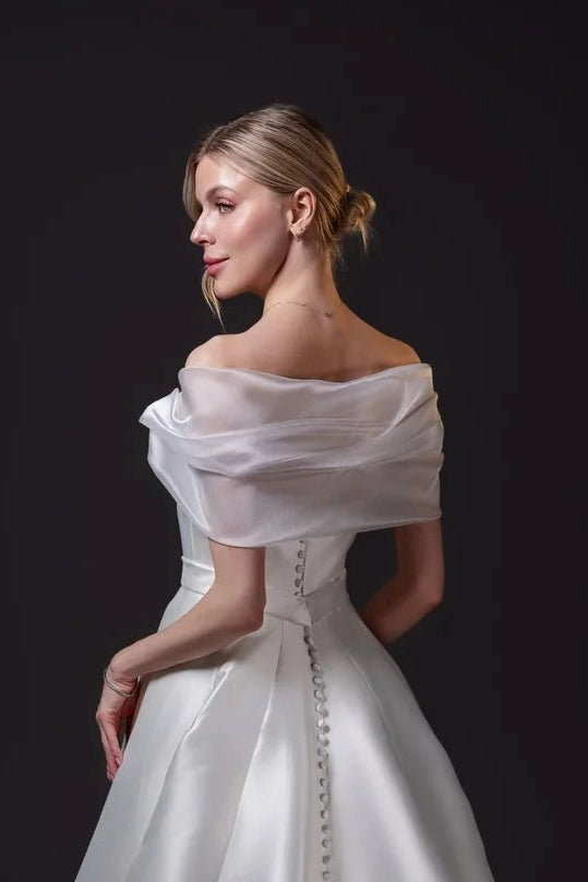 Mirabel removable organza bridal shawl draped off the shoulders, designed to complement the Mirabel Gown in Toronto.