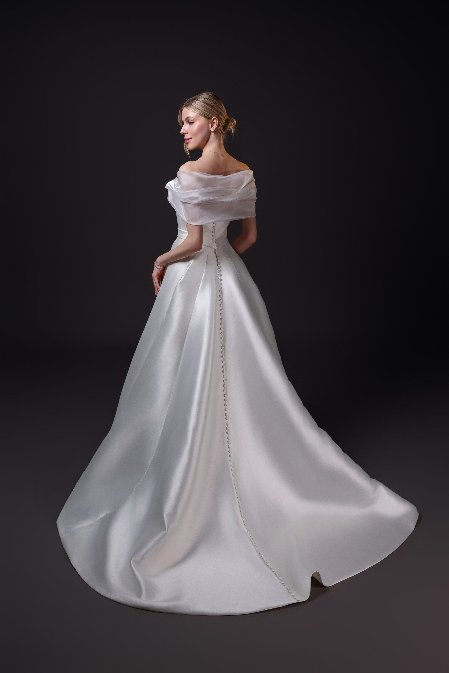 Mirabel silk blend Mikado ball gown with a Basque waistline, bow draped bodice, and full skirt with pockets, Toronto.