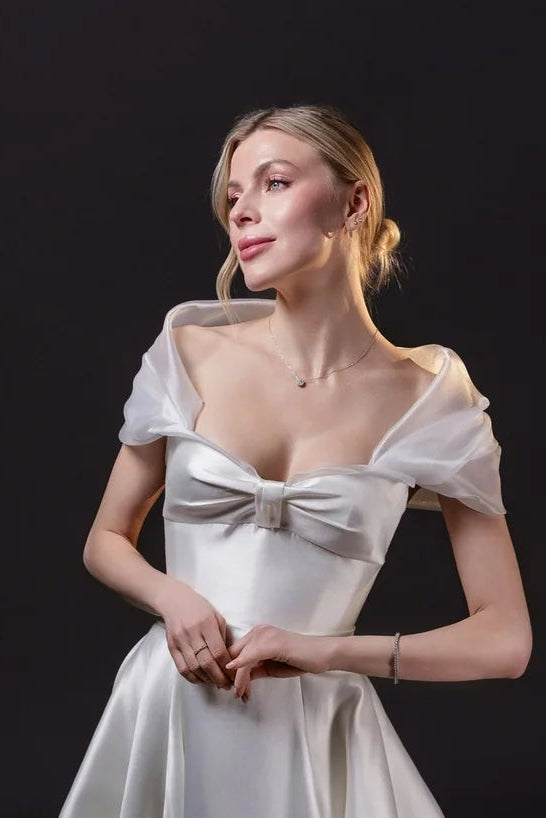 Mirabel removable organza bridal shawl draped off the shoulders, designed to complement the Mirabel Gown in Toronto.