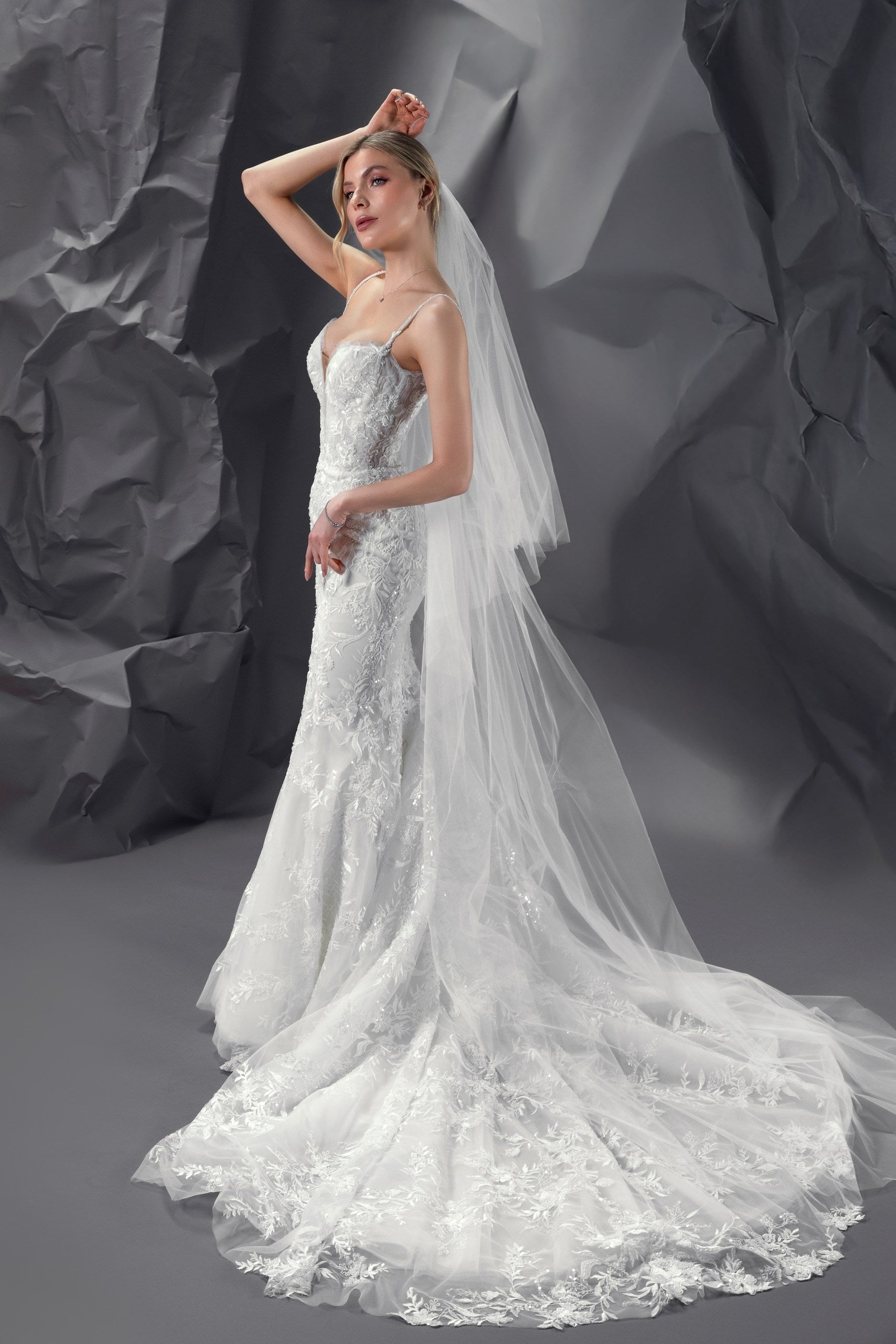 Nicole beaded lace mermaid wedding gown with a built-in corset, hand-beaded straps, and an extra-long train in Toronto.