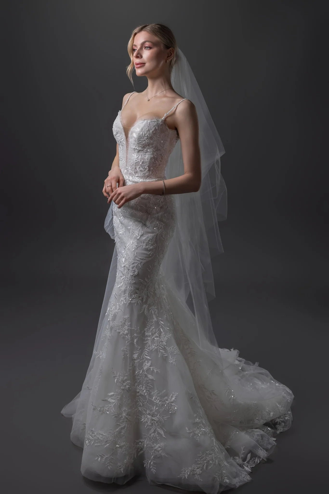 Nicole beaded lace mermaid wedding gown with a built-in corset, hand-beaded straps, and an extra-long train in Toronto.