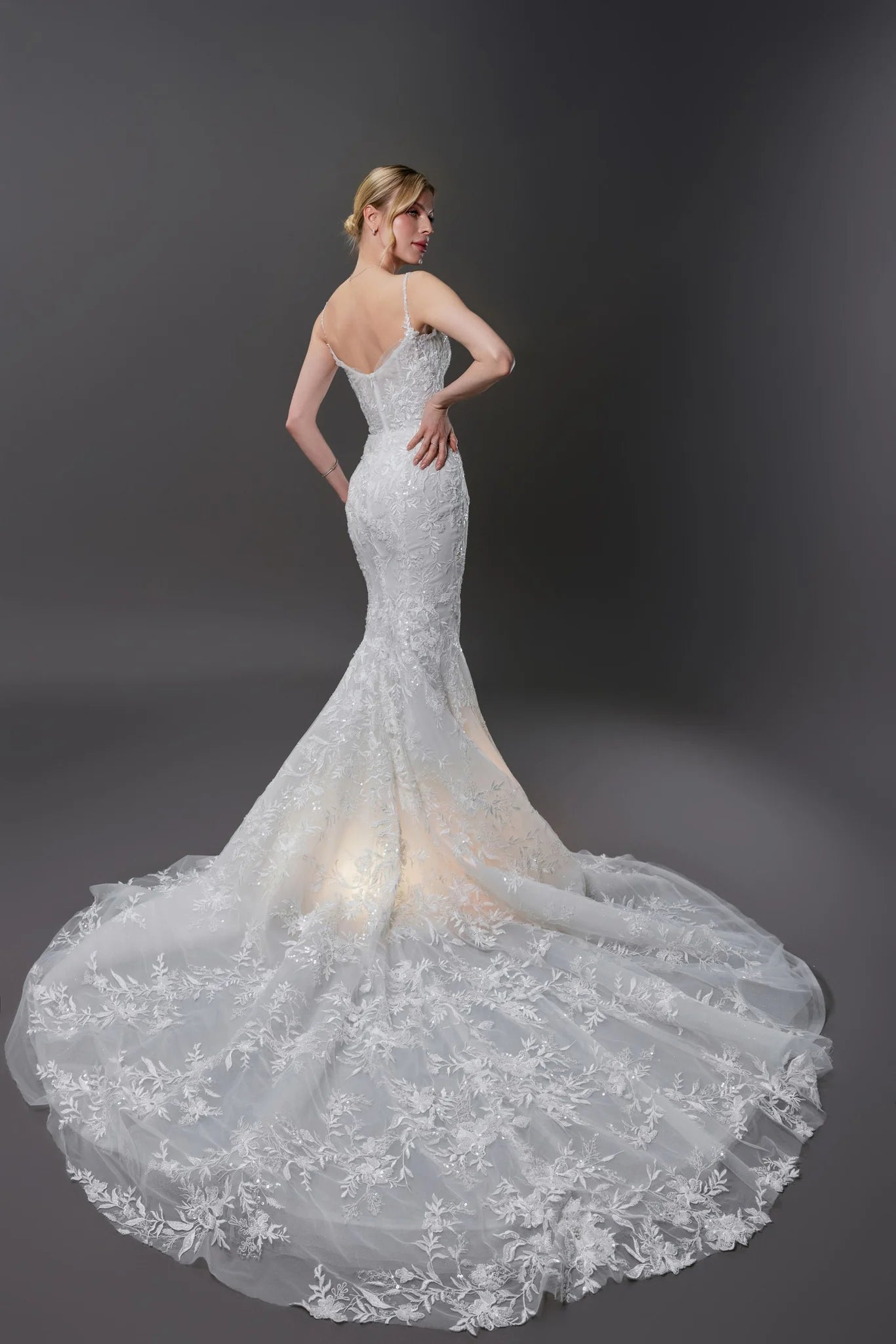 Nicole beaded lace mermaid wedding gown with a built-in corset, hand-beaded straps, and an extra-long train in Toronto.