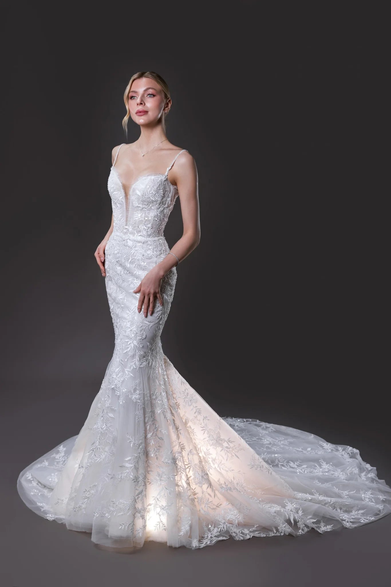 Nicole beaded lace mermaid wedding gown with a built-in corset, hand-beaded straps, and an extra-long train in Toronto.