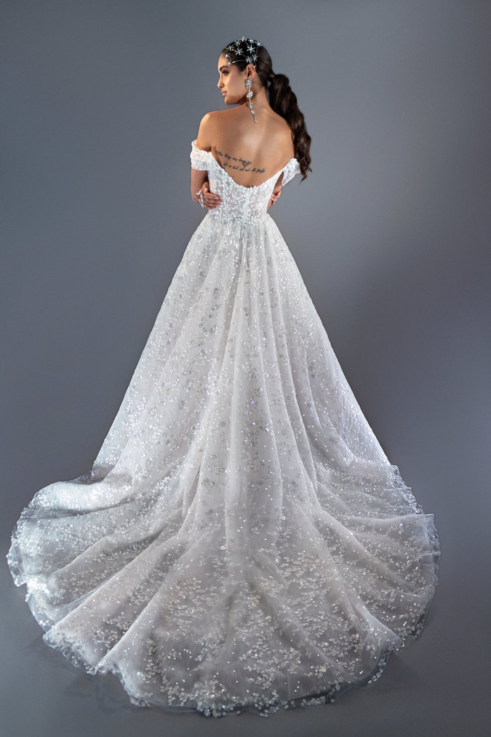 Nova off-the-shoulder lace ball gown wedding dress with corset bodice and deep V neckline in Toronto.