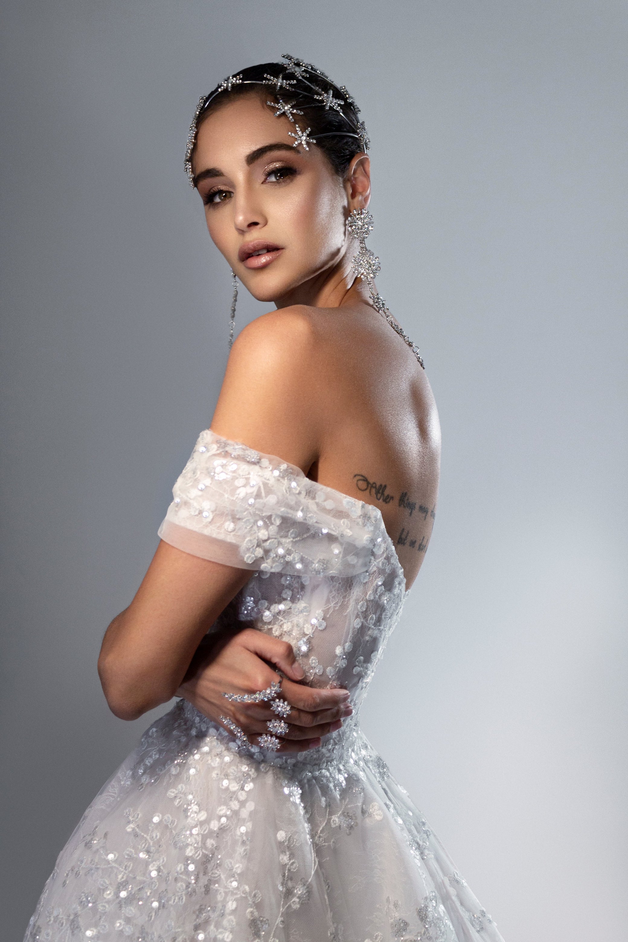 Nova off-the-shoulder lace ball gown wedding dress with corset bodice and deep V neckline in Toronto.