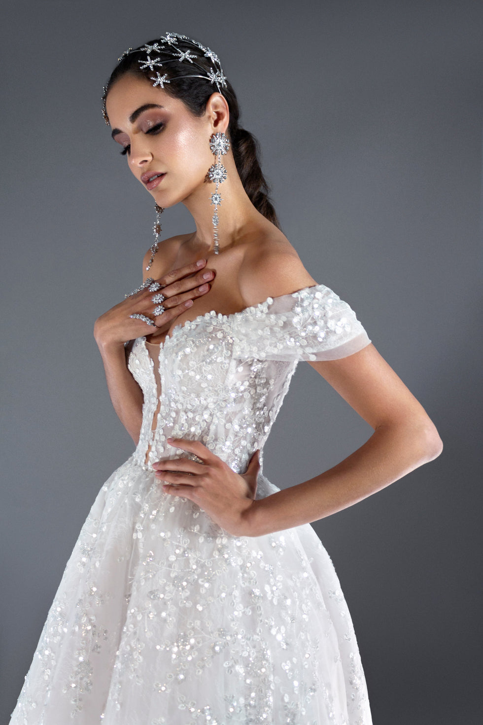Nova off-the-shoulder lace ball gown wedding dress with corset bodice and deep V neckline in Toronto.