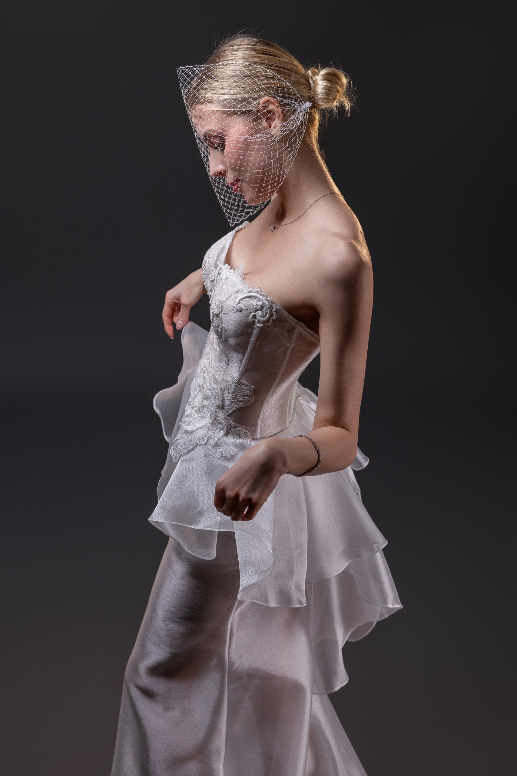 Olivia transparent textured organza fit and flare wedding gown with a boned corset and hand-cut silk flowers, Toronto.