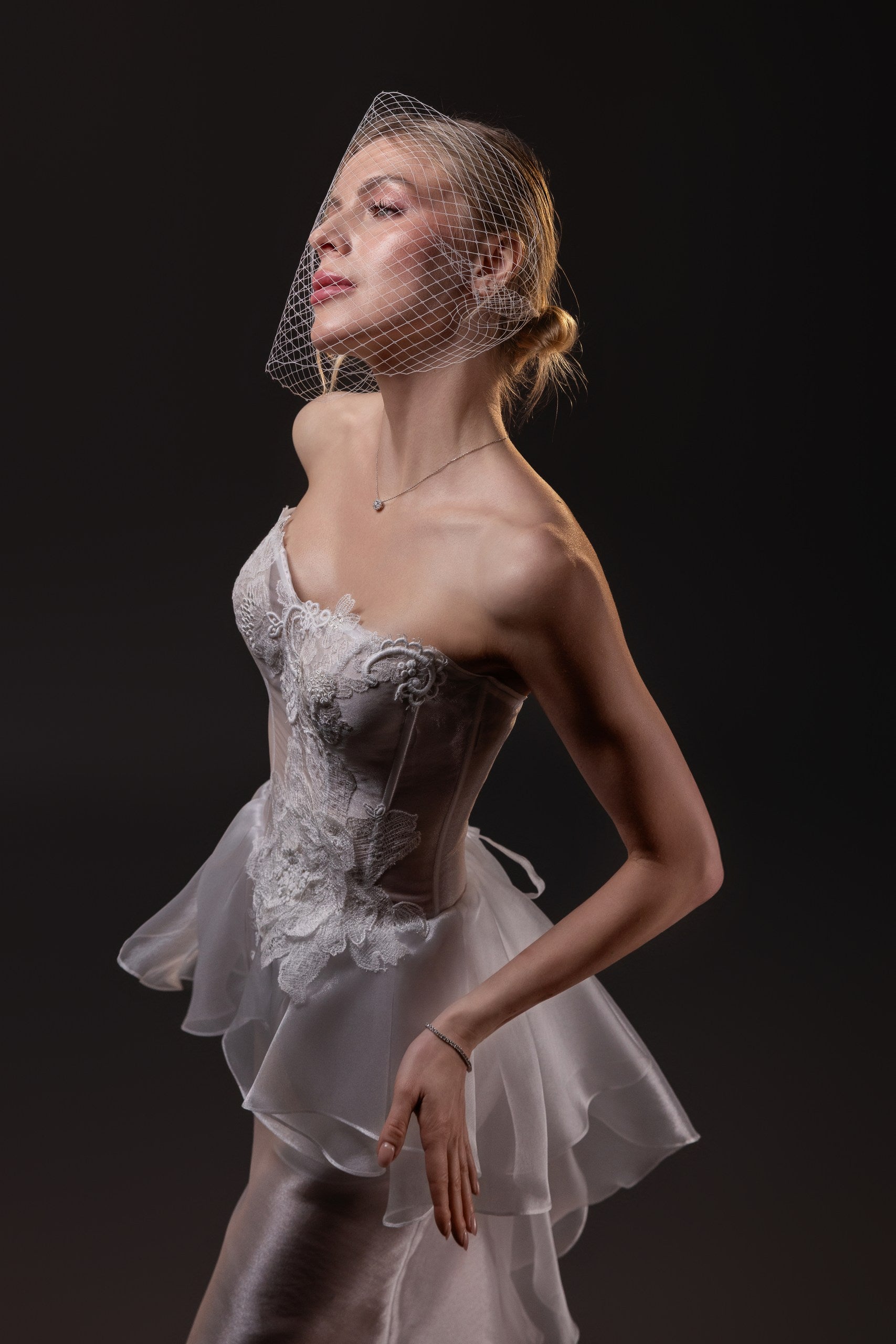 Olivia transparent textured organza fit and flare wedding gown with a boned corset and hand-cut silk flowers, Toronto.