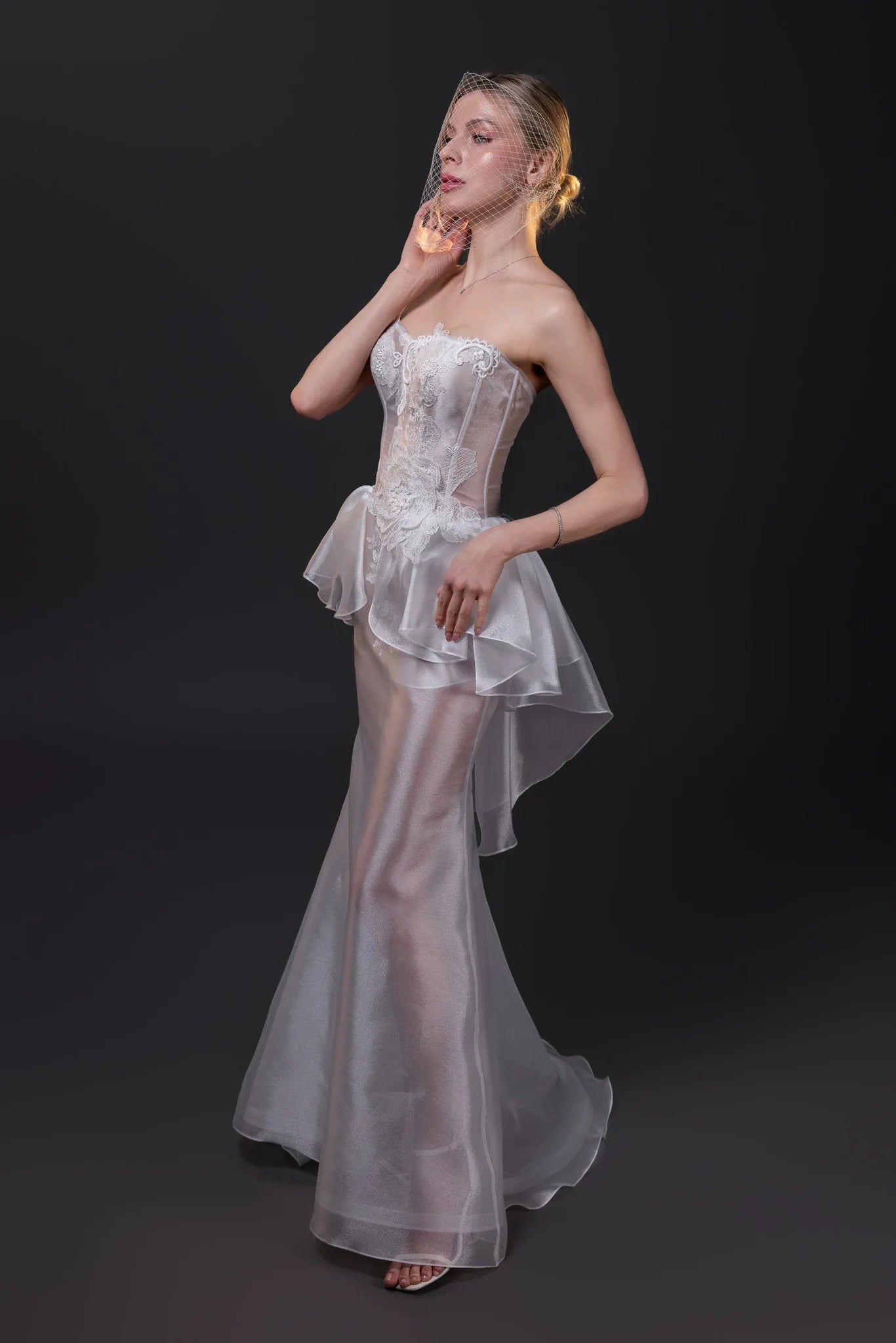 Olivia transparent textured organza fit and flare wedding gown with a boned corset and hand-cut silk flowers, Toronto.