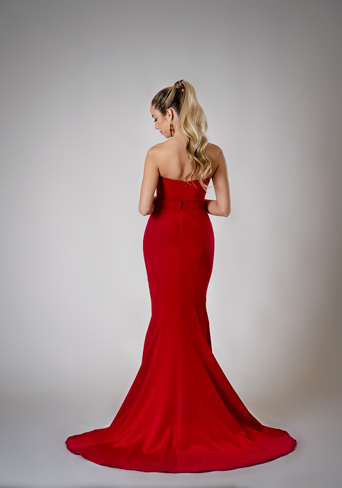 Scarlet silk crepe fit and flare evening gown with a built-in corset, sculpted neckline, crystal brooch, and front slit in Toronto.